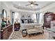 Serene main bedroom featuring tray ceilings, natural light, and elegant decor at 296 Switchgrass Loop, Little River, SC 29566