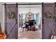 Elegant music room featuring a grand piano, custom sliding doors, and serene decor at 296 Switchgrass Loop, Little River, SC 29566