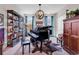 Detailed view of the music room with a grand piano, bookshelf, and decorative lighting at 296 Switchgrass Loop, Little River, SC 29566