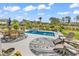 Relaxing pool area with lounge chairs, outdoor seating, and landscaped garden at 296 Switchgrass Loop, Little River, SC 29566