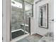 Contemporary shower with gray tiling, glass door, and built-in bench seating at 296 Switchgrass Loop, Little River, SC 29566