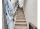 Carpeted staircase with decorative garland and wall decor leading to the upper level at 296 Switchgrass Loop, Little River, SC 29566