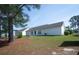 Serene backyard featuring a lush lawn, mature trees, and ample space for outdoor enjoyment at 331 Andorra St., Longs, SC 29568