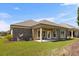 Backyard of the house with a small covered patio and green grass at 331 Las Olas Dr., Myrtle Beach, SC 29577