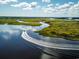Aerial view of the Intracoastal Waterway with boat speeding along and waterways throughout marshy landscape at 3316 Bay View Ct., North Myrtle Beach, SC 29582