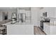 Modern kitchen with stainless steel appliances, white cabinetry, and a spacious island at 3316 Bay View Ct., North Myrtle Beach, SC 29582