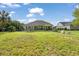 Spacious backyard featuring a large lawn, a black metal fence, and a home exterior at 4016 Atalaya Pl., Myrtle Beach, SC 29579