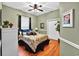 Comfortable bedroom featuring neutral green walls, wood floors and a ceiling fan at 4016 Atalaya Pl., Myrtle Beach, SC 29579