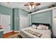 Calming bedroom with cool, light green walls, white trim, and a ceiling fan at 4016 Atalaya Pl., Myrtle Beach, SC 29579