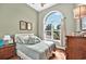 Sunlit bedroom featuring a large arched window and warm, earthy tones at 4016 Atalaya Pl., Myrtle Beach, SC 29579