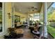 A covered patio area has comfortable seating arrangements, creating an inviting outdoor space for relaxation and entertaining at 4016 Atalaya Pl., Myrtle Beach, SC 29579