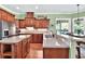 Spacious kitchen with custom wood cabinetry, stone countertops, and stainless steel appliances at 4016 Atalaya Pl., Myrtle Beach, SC 29579