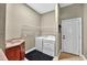 The practical laundry room features a sink, washer, dryer, and convenient shelving, maximizing functionality and storage at 4016 Atalaya Pl., Myrtle Beach, SC 29579