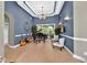 Elegant living room with stylish blue walls, a piano, and ample natural light at 4016 Atalaya Pl., Myrtle Beach, SC 29579
