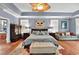 The primary bedroom is spacious with hardwood floors, tray ceilings and abundant natural light at 4016 Atalaya Pl., Myrtle Beach, SC 29579