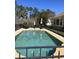 Outdoor pool area with ample seating, landscaping, and a wrought iron fence at 4016 Atalaya Pl., Myrtle Beach, SC 29579