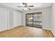 Bright bedroom featuring light wood floors, neutral walls, a ceiling fan, and sliding glass doors to the balcony at 404 72Nd Ave. N # 206, Myrtle Beach, SC 29572