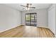 Bright bedroom featuring light wood floors, neutral walls, a ceiling fan, and sliding glass doors to the balcony at 404 72Nd Ave. N # 206, Myrtle Beach, SC 29572