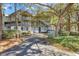 Exterior view of multi-story condo building with lush greenery and covered parking at 404 72Nd Ave. N # 206, Myrtle Beach, SC 29572