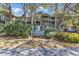 Inviting condo complex with mature trees and community signage on Spinnakers Reach, offering a tranquil coastal living experience at 404 72Nd Ave. N # 206, Myrtle Beach, SC 29572