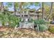 Charming exterior view of multi-story condo building with lush greenery and community signage at 404 72Nd Ave. N # 206, Myrtle Beach, SC 29572