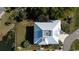 Aerial view of the home showcasing a white metal roof and lush landscaping at 4240 Highway 17 Business, Murrells Inlet, SC 29576
