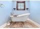 Close-up of a luxurious freestanding bathtub with brass fixtures at 4240 Highway 17 Business, Murrells Inlet, SC 29576
