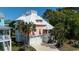 Beautiful exterior view of home featuring a multi car garage, a metal roof and lush tropical landscaping at 4240 Highway 17 Business, Murrells Inlet, SC 29576