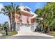 Stunning home featuring tropical landscaping, a large driveway, and a multi-car garage with ample parking at 4240 Highway 17 Business, Murrells Inlet, SC 29576