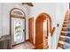Inviting foyer with tile floors, arched doorways, and a unique stained-glass front door with a tropical design at 4240 Highway 17 Business, Murrells Inlet, SC 29576