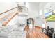 Bright living room with high ceilings, hardwood floors, a spiral staircase, and an open-concept design at 4240 Highway 17 Business, Murrells Inlet, SC 29576