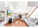 Bright living room with hardwood floors, a fireplace, transom windows, and comfortable seating at 4240 Highway 17 Business, Murrells Inlet, SC 29576