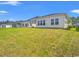 Expansive backyard view highlighting the well-maintained lawn and neighboring houses under a blue sky at 5019 Riverton Ct, Myrtle Beach, SC 29579