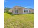 Exterior shot of the home's back, showing a covered patio and a lush, green lawn at 5019 Riverton Ct, Myrtle Beach, SC 29579
