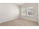 Bedroom featuring neutral carpet and walls, trim and window with view at 5019 Riverton Ct, Myrtle Beach, SC 29579