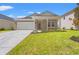 Charming single-story home boasts a manicured lawn and a welcoming entrance, with bright blue skies above at 5019 Riverton Ct, Myrtle Beach, SC 29579