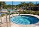 Inviting hot tub with tile accents, set near a large pool and lush landscaping, offers relaxation and comfort at 524 Farrow Pkwy., Myrtle Beach, SC 29577