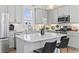Modern kitchen with island, quartz countertops, stainless steel appliances, and gray cabinetry at 524 Farrow Pkwy., Myrtle Beach, SC 29577
