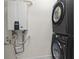 Modern laundry room with stacked washer and dryer and a tankless water heater at 524 Farrow Pkwy., Myrtle Beach, SC 29577