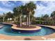 Beautifully landscaped lazy river features tropical palm trees and a tranquil water feature for leisurely enjoyment at 524 Farrow Pkwy., Myrtle Beach, SC 29577