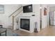 Bright living room features hardwood floors, fireplace with TV, and staircase access to the second floor at 524 Farrow Pkwy., Myrtle Beach, SC 29577