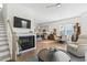 Open-concept living space with fireplace, hardwood floors, kitchen access, and comfortable furnishings at 524 Farrow Pkwy., Myrtle Beach, SC 29577