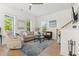 Cozy living room with hardwood floors, neutral furniture, and ample natural light from large windows at 524 Farrow Pkwy., Myrtle Beach, SC 29577