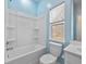 Bright bathroom featuring a tub and shower combination with a window for natural light at 5333 Abbey Park Loop, Myrtle Beach, SC 29579