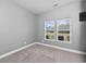 Well-lit bedroom with neutral carpet, a mounted TV, and large windows offering plenty of natural light at 5333 Abbey Park Loop, Myrtle Beach, SC 29579