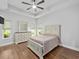 Spacious main bedroom with tray ceiling, ceiling fan, and wood-look flooring at 5333 Abbey Park Loop, Myrtle Beach, SC 29579