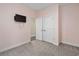 Cozy bedroom with a wall-mounted TV and double doors leading to another room, carpeted for warmth at 5333 Abbey Park Loop, Myrtle Beach, SC 29579