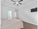 Large main bedroom featuring tray ceilings, fan, wood-look flooring, and ensuite bathroom at 5333 Abbey Park Loop, Myrtle Beach, SC 29579