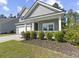 Charming home with a landscaped garden and a cozy front porch, perfect for enjoying the outdoors at 5333 Abbey Park Loop, Myrtle Beach, SC 29579