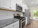 Updated kitchen features stainless steel appliances, granite countertops, and white subway tile backsplash at 5333 Abbey Park Loop, Myrtle Beach, SC 29579